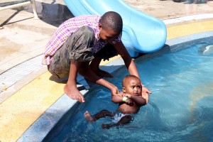 Volunteer - man and child in pool